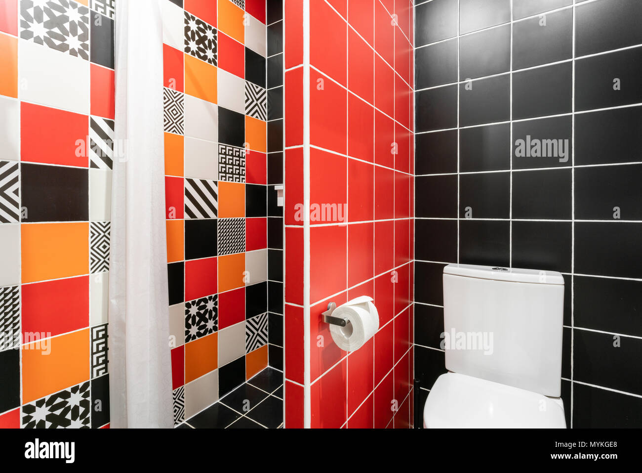 Bathroom with shower, toilet bowl and sink. Hotel standart bedroom. simple  and stylish interior. interior lighting Stock Photo - Alamy