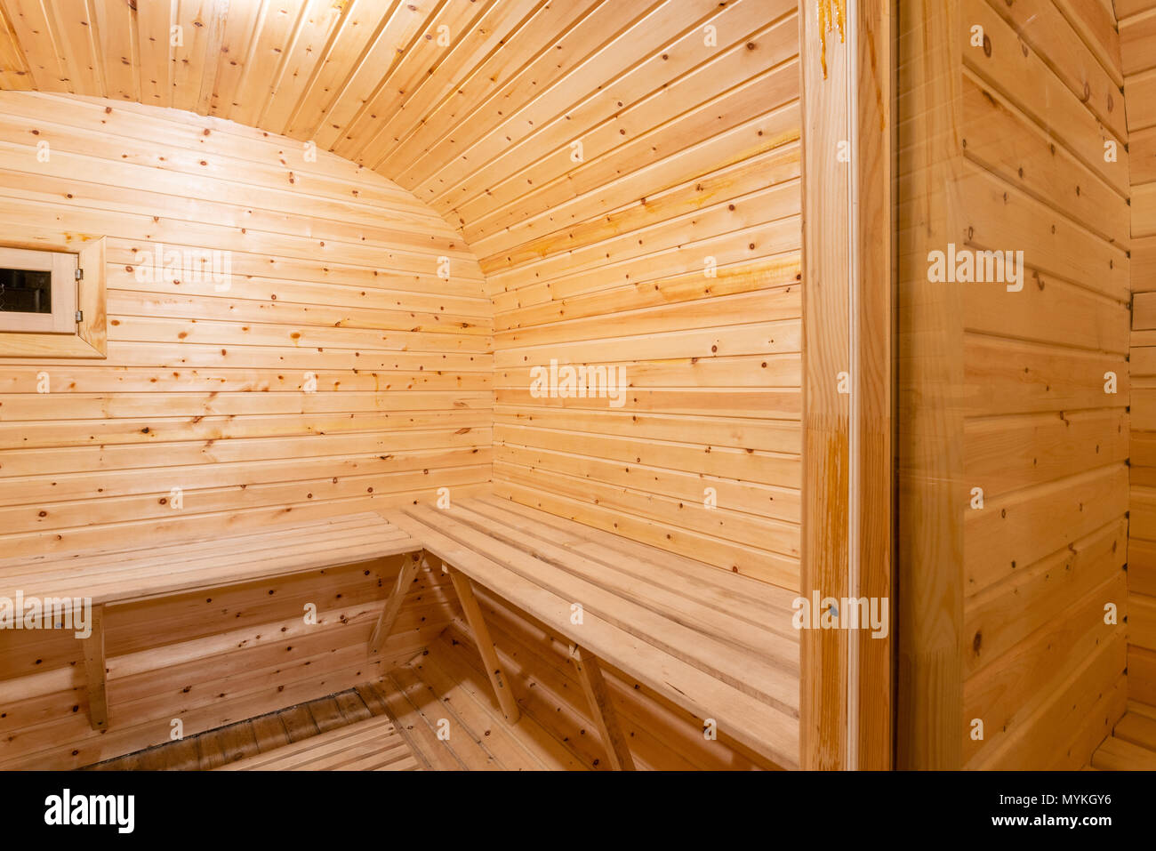 interior of sauna. rural mobile wooden bath in the form of a barrel in