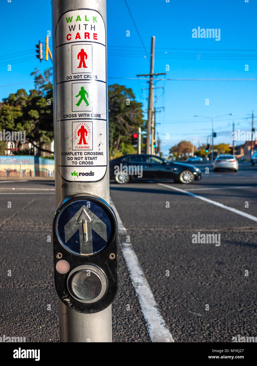 Pedestrian crossing button and instructions at a busy intersection on Melbourne's suburban street. VIC Australia. Stock Photo