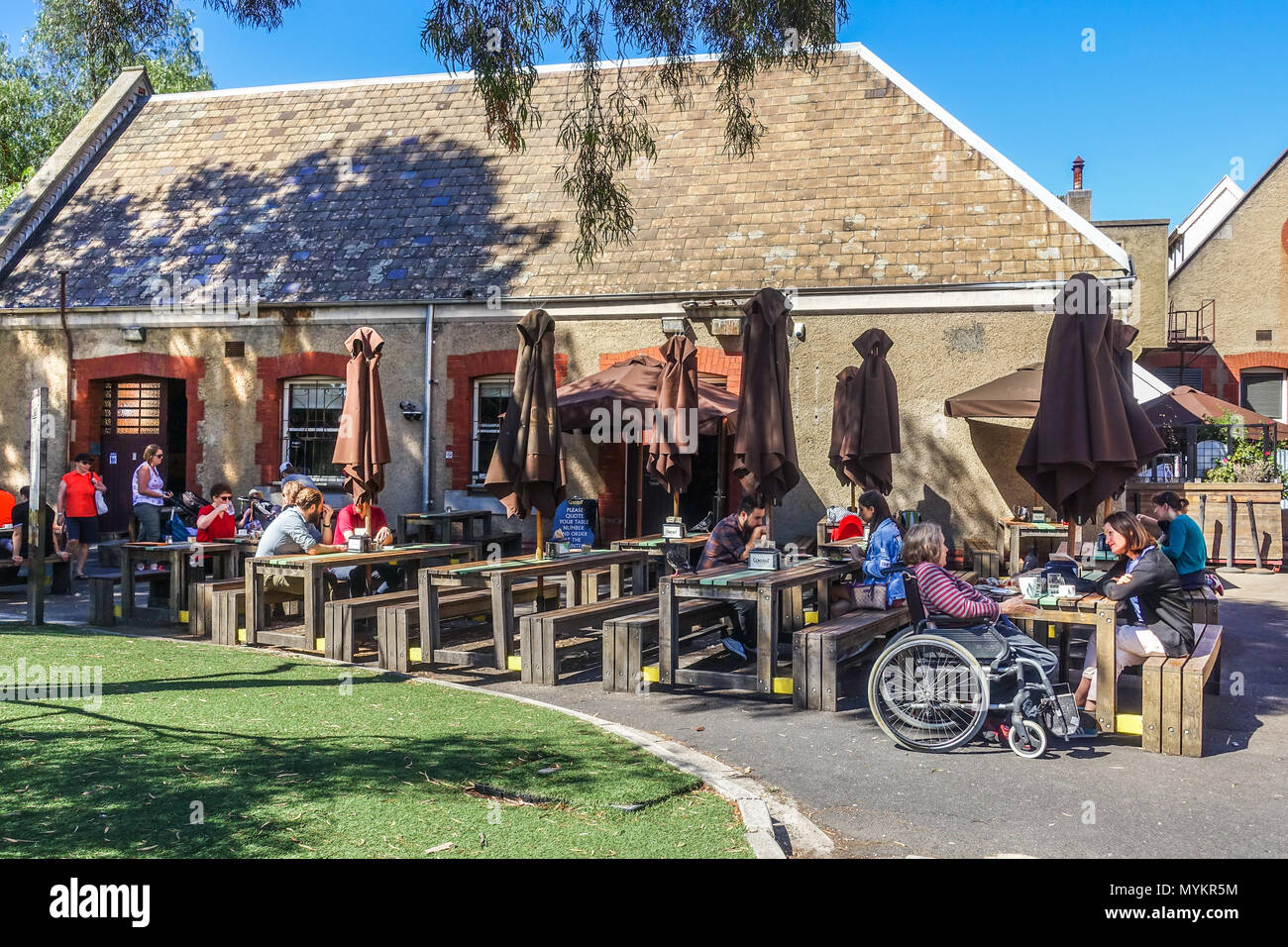 People enjoy their meals at outdoor dinning area at Convent Bakery, Abbotsford VIC Australia. Stock Photo