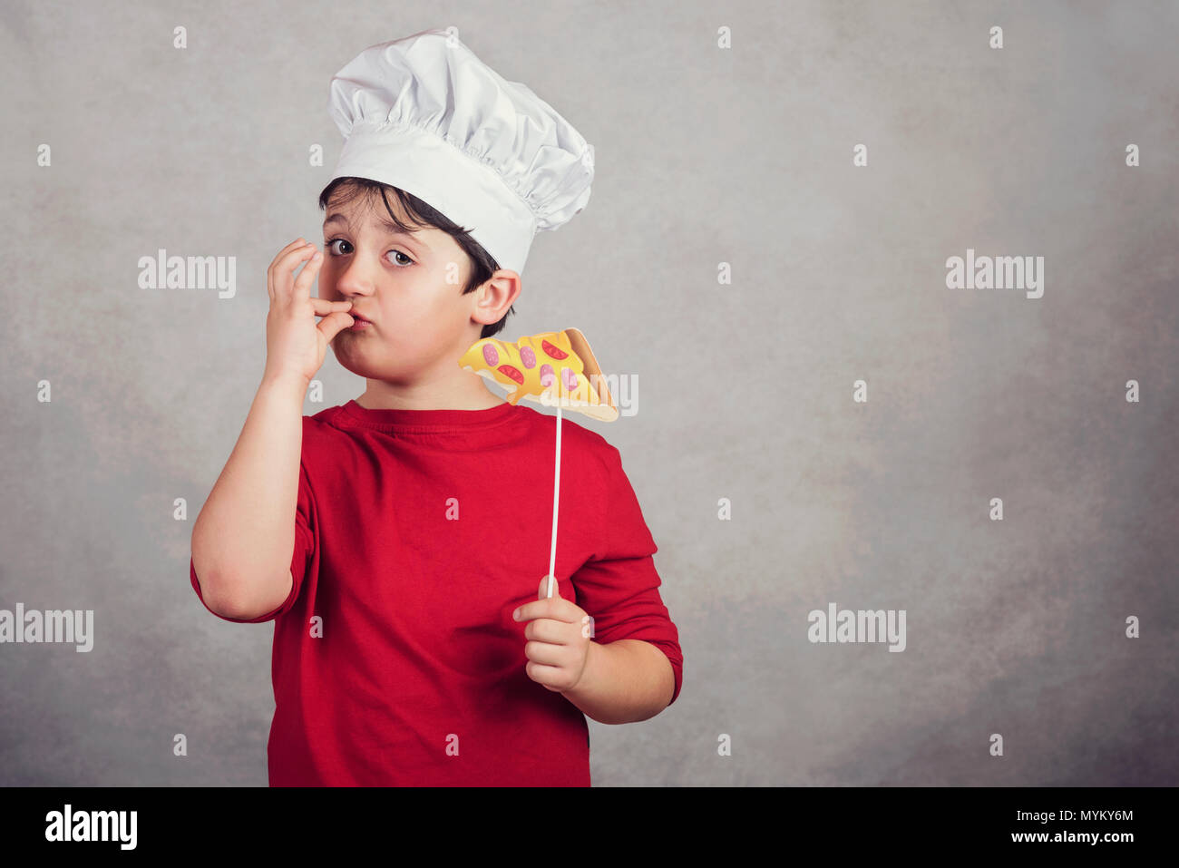 child funny cook with slice pizza Stock Photo