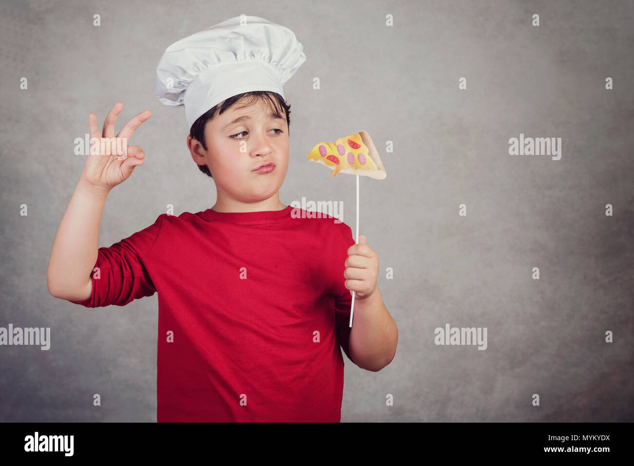 child funny cook with slice pizza Stock Photo