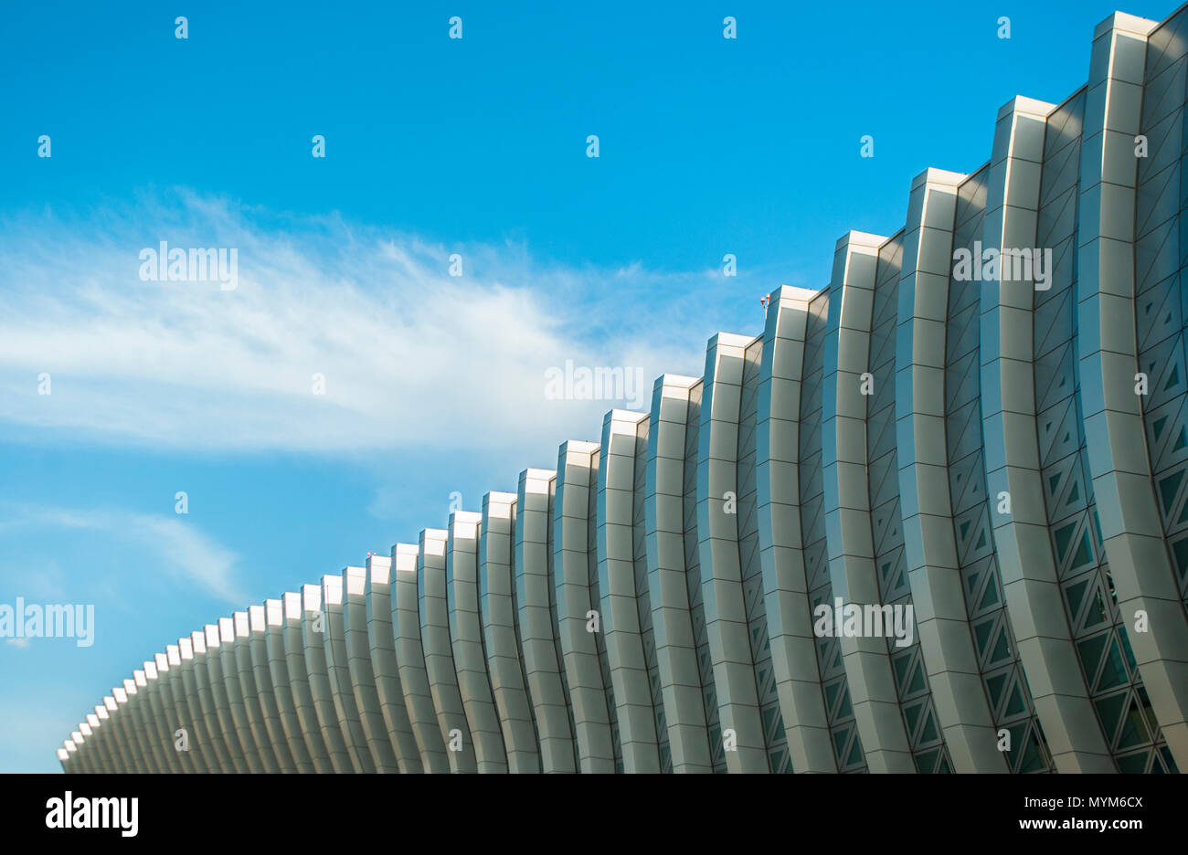 Contemporary geometric facade of a building with wavy lines. Stock Photo