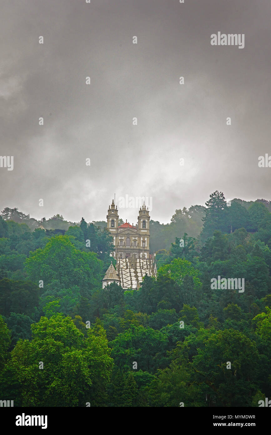 Bom Jesus do Monte church surrounded by forest and clouds. Braga. Stock Photo