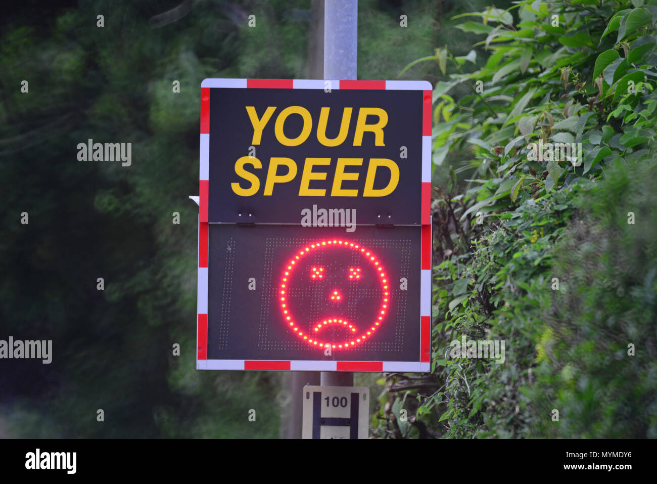digital speed warning sign showing sad face when passing drivers are