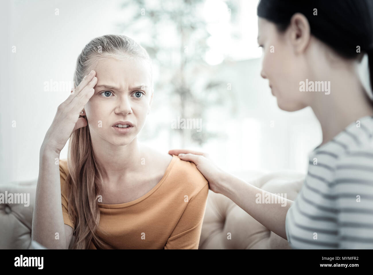 Female psychologist tranquilizing anxious teen girl Stock Photo Alamy