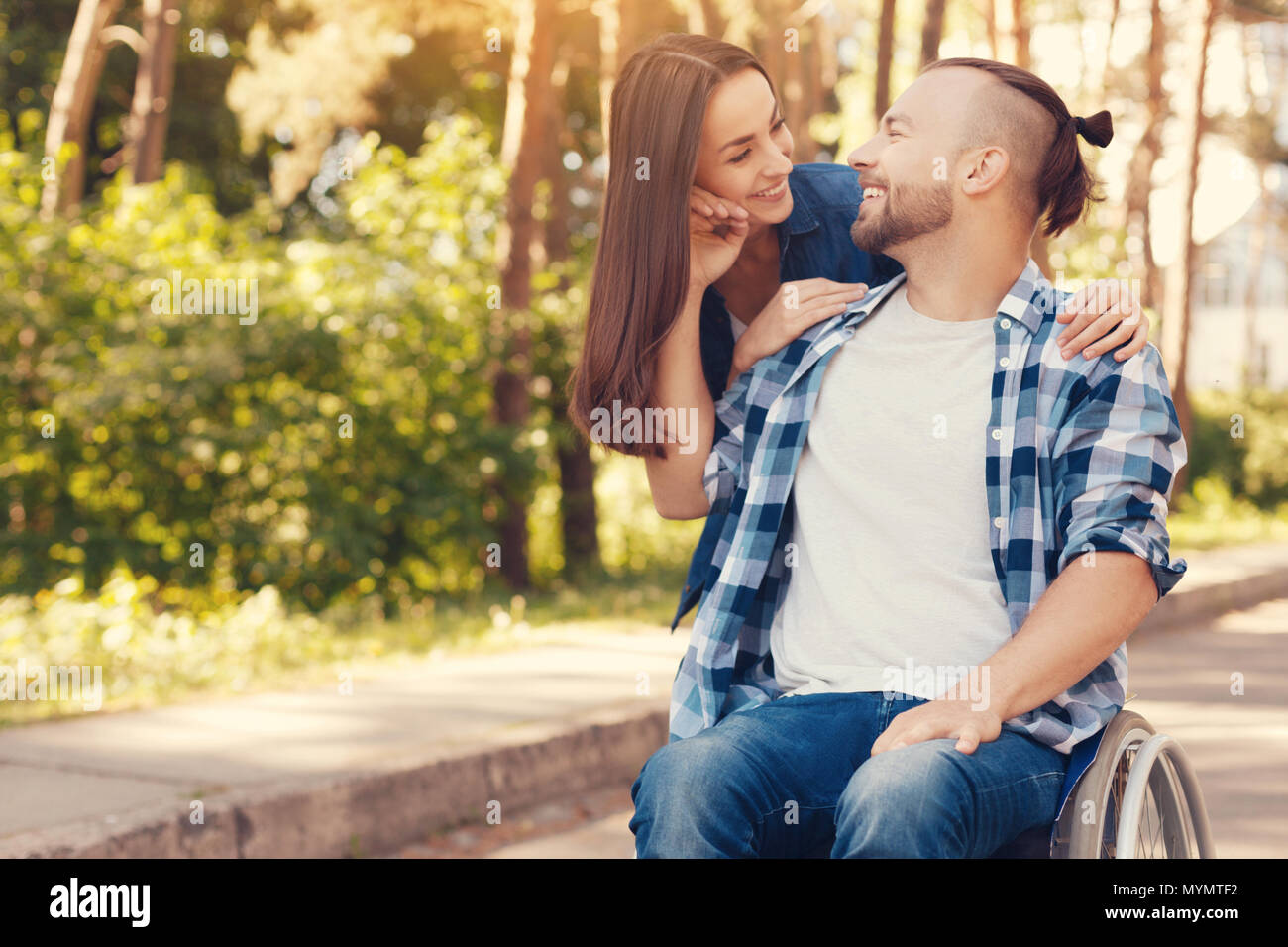 Cheerful disabled man looking at his girlfriend Stock Photo