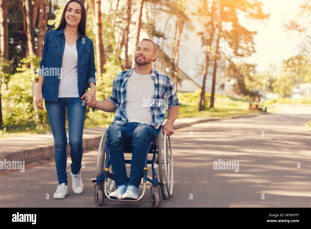 Positive nice couple holding hands Stock Photo