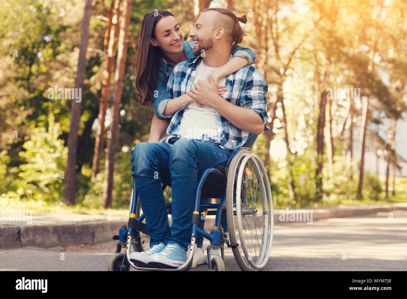 Happy disabled man spending time with girlfriend Stock Photo