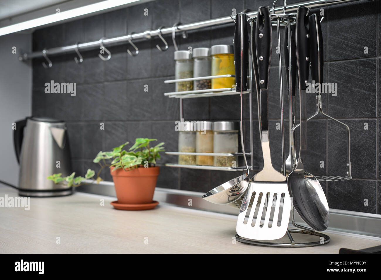 Kitchen utensils on work top in modern kitchen closeup Stock Photo