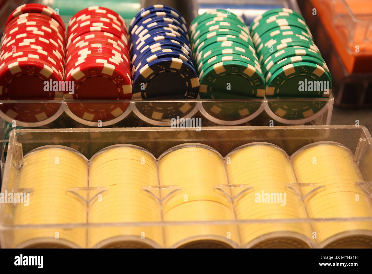 Calling all gamblers: roulette wheel, caps table, and poker chips. Stock Photo