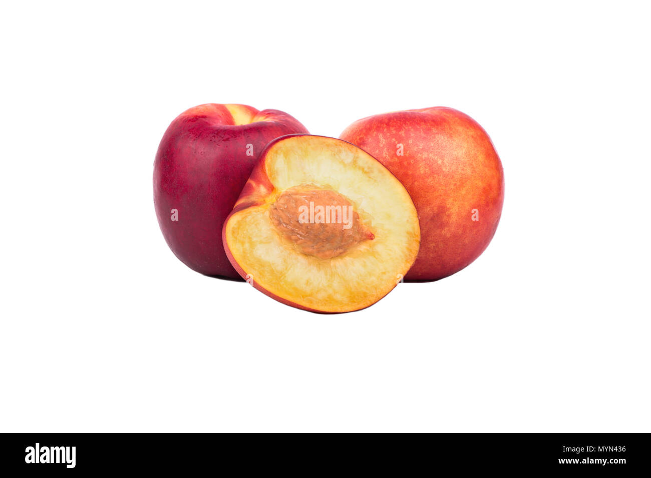 Two fresh nectarines with half a fruit on a white background Stock Photo