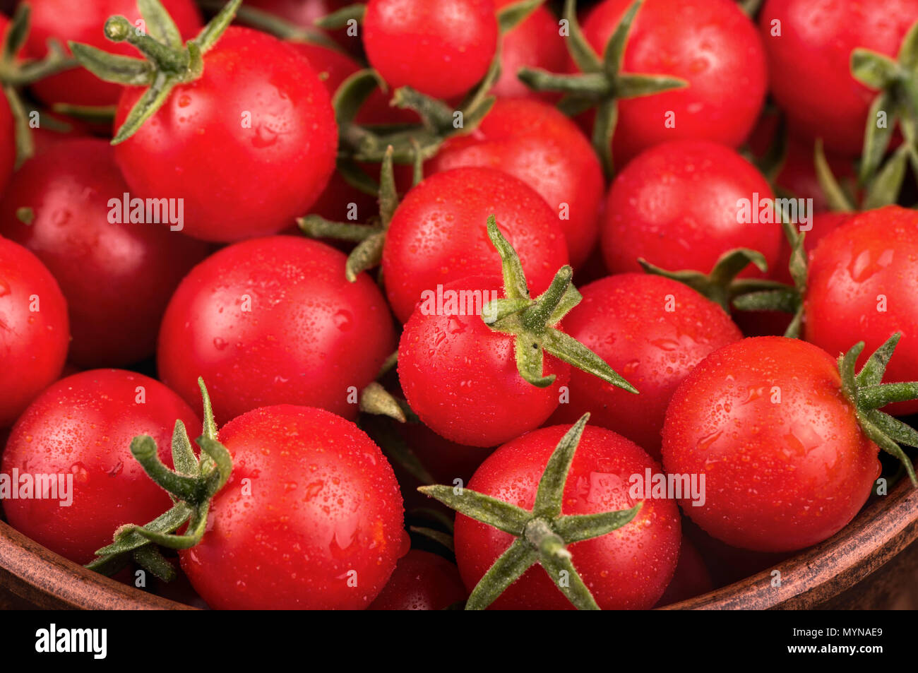 Full bowl of fresh small red cherry tomatoes with drops close-up Stock ...