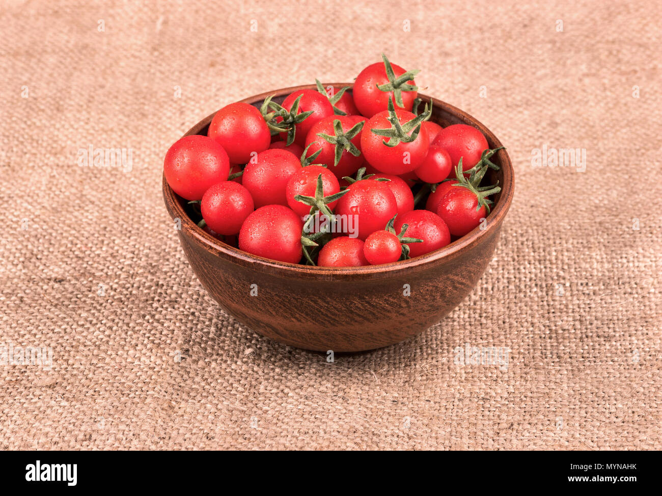 Full bowl of fresh red cherry tomatoes on sacking Stock Photo - Alamy