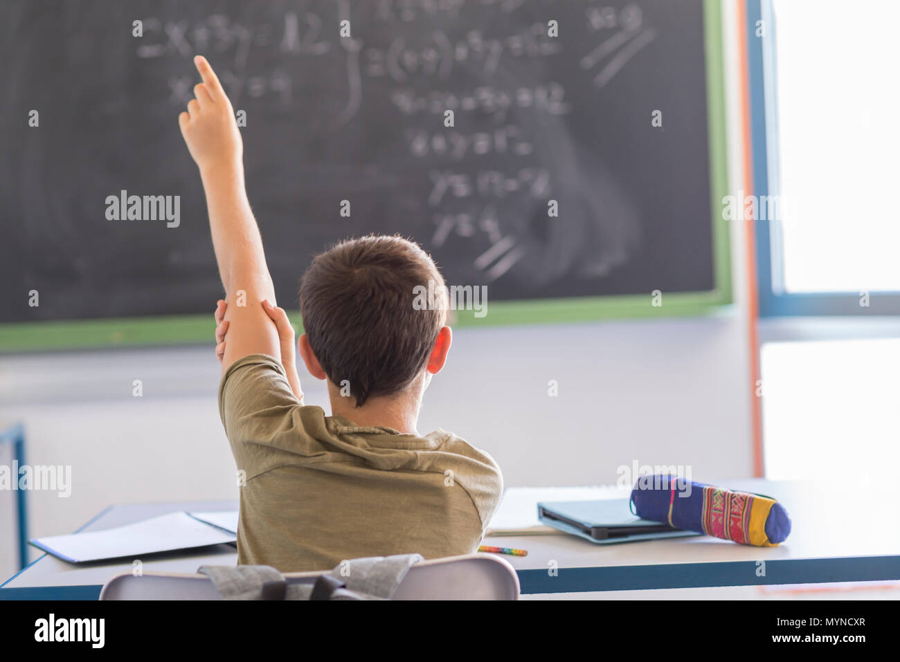 Daily day in a class room at school. Child attending to the lesson on ...