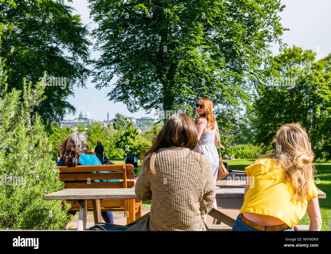 Group of pretty young women at cafe, with one saying goodbye, Edinburgh, Scotland, UK Stock Photo