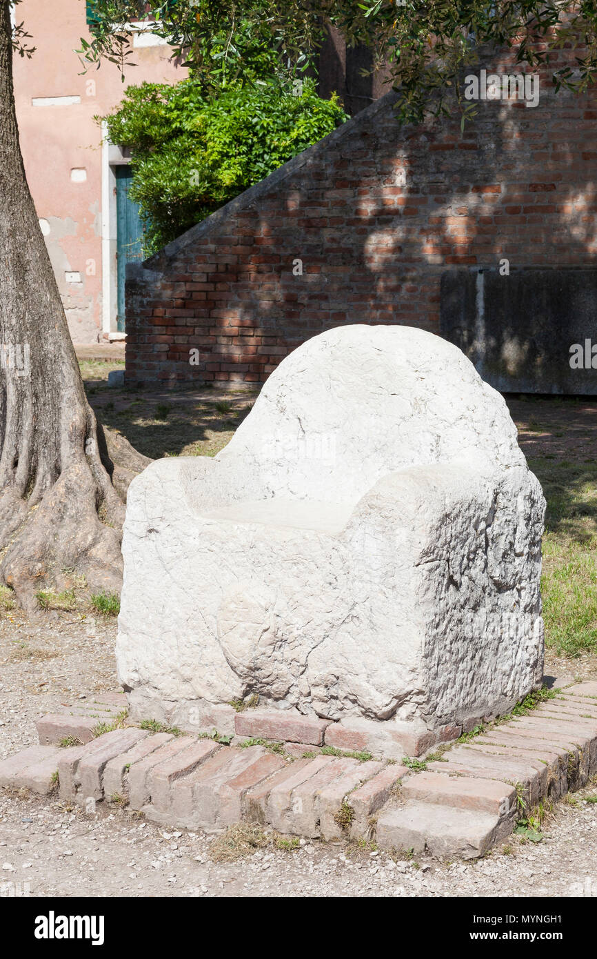 The legendry marble Throne of Attila the Hun, Torcello Island, Venice, Veneto, Italy  in front of the Museum in reality used by the magister militum,  Stock Photo