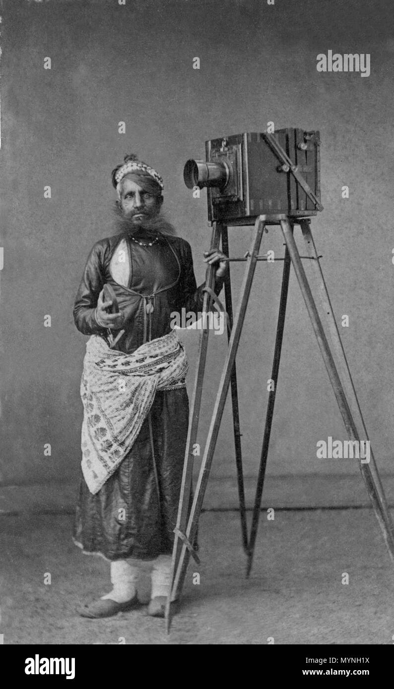 . English: Portrait of Mohan Lal with His Camera Date:  ca. 1875 Culture:  India (Udaipur, Mewar, Rajasthan) Medium:  Albumen print Dimensions:  Overall: 3 7/8 x 2 5/16 in. (9.8 x 5.8 cm) Mount: 4 1/8 x 2 1/2 in. (10.4 x 6.3 cm) Classification:  Photograph Credit Line:  Lent by Maharana of Mewar Charitable Foundation, The City Palace Complex, Udaipur Accession Number: SL.17.2011.22.9 . circa 1875. Unknown 433 Portrait of Mohan Lal with His Camera Stock Photo