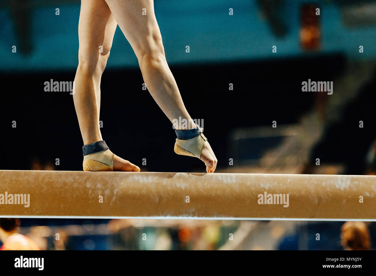 artistic gymnastics legs women gymnast exercises on balance beam Stock Photo