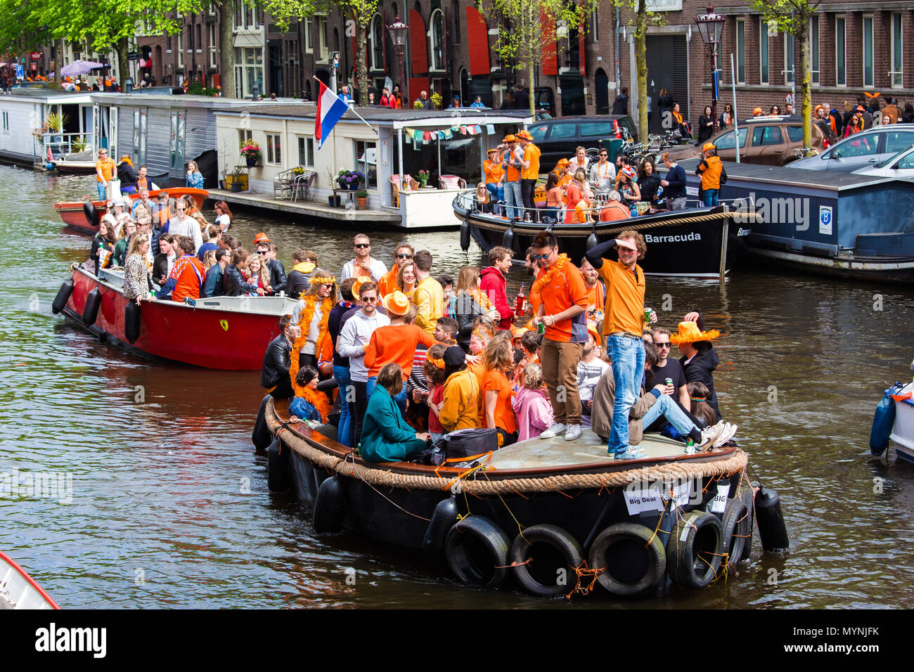 People on the boat celebrate King's day in Amsterdam city, Netherlands Stock Photo