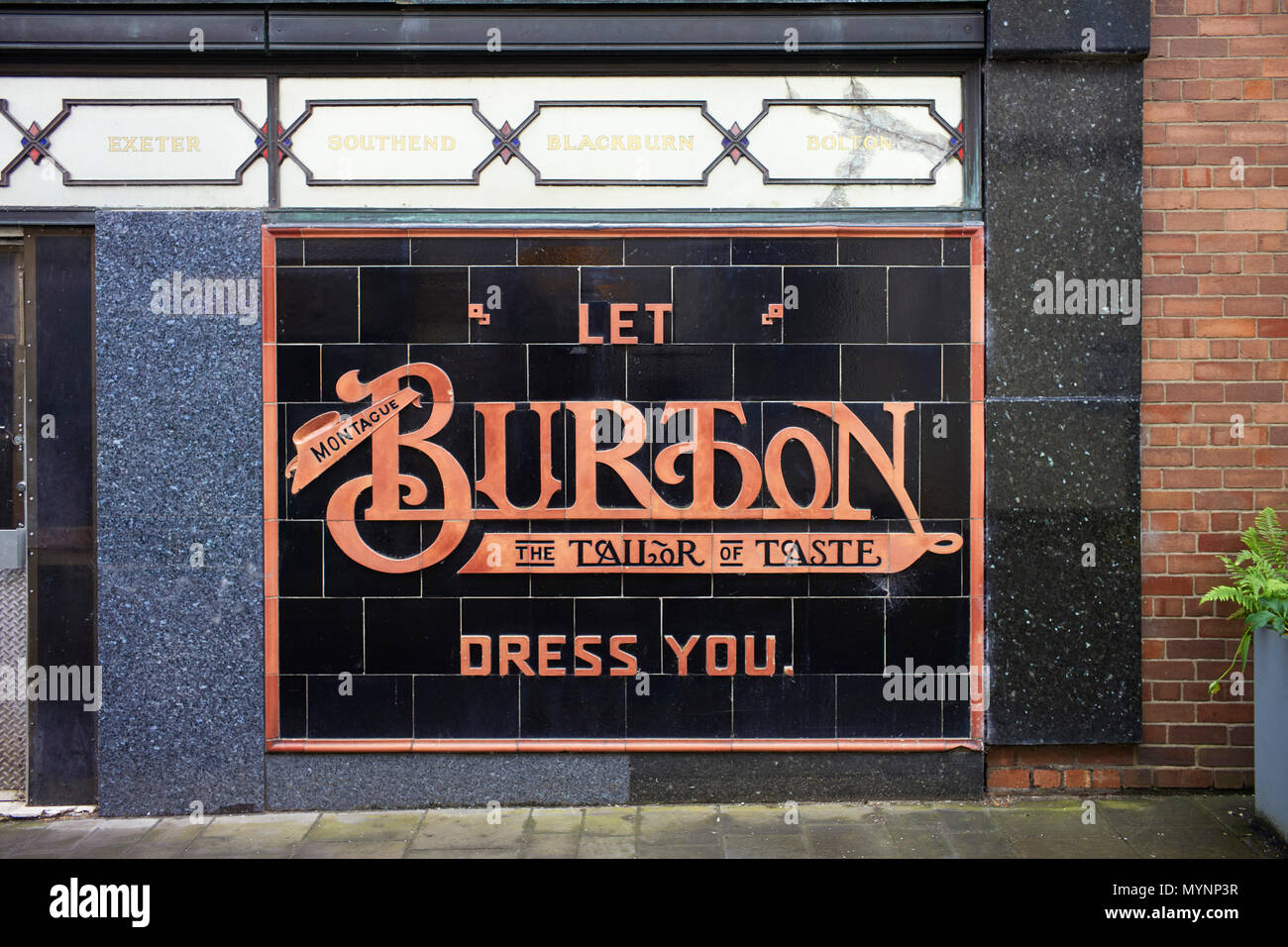 Tiled sign outside a closed branch of Burton Tailors in Abervagenny, Wales Stock Photo