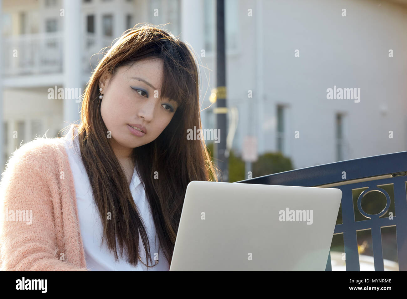 Asian woman working on laptop computer Stock Photo