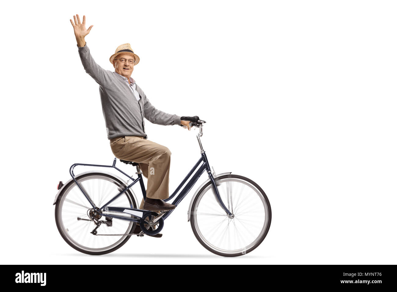 Mature man riding a bicycle and waving at the camera isolated on white background Stock Photo