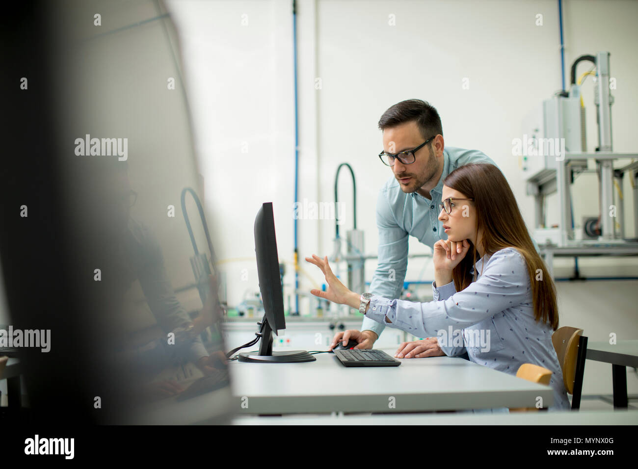 Young students presenting e-learning service in classroom Stock Photo