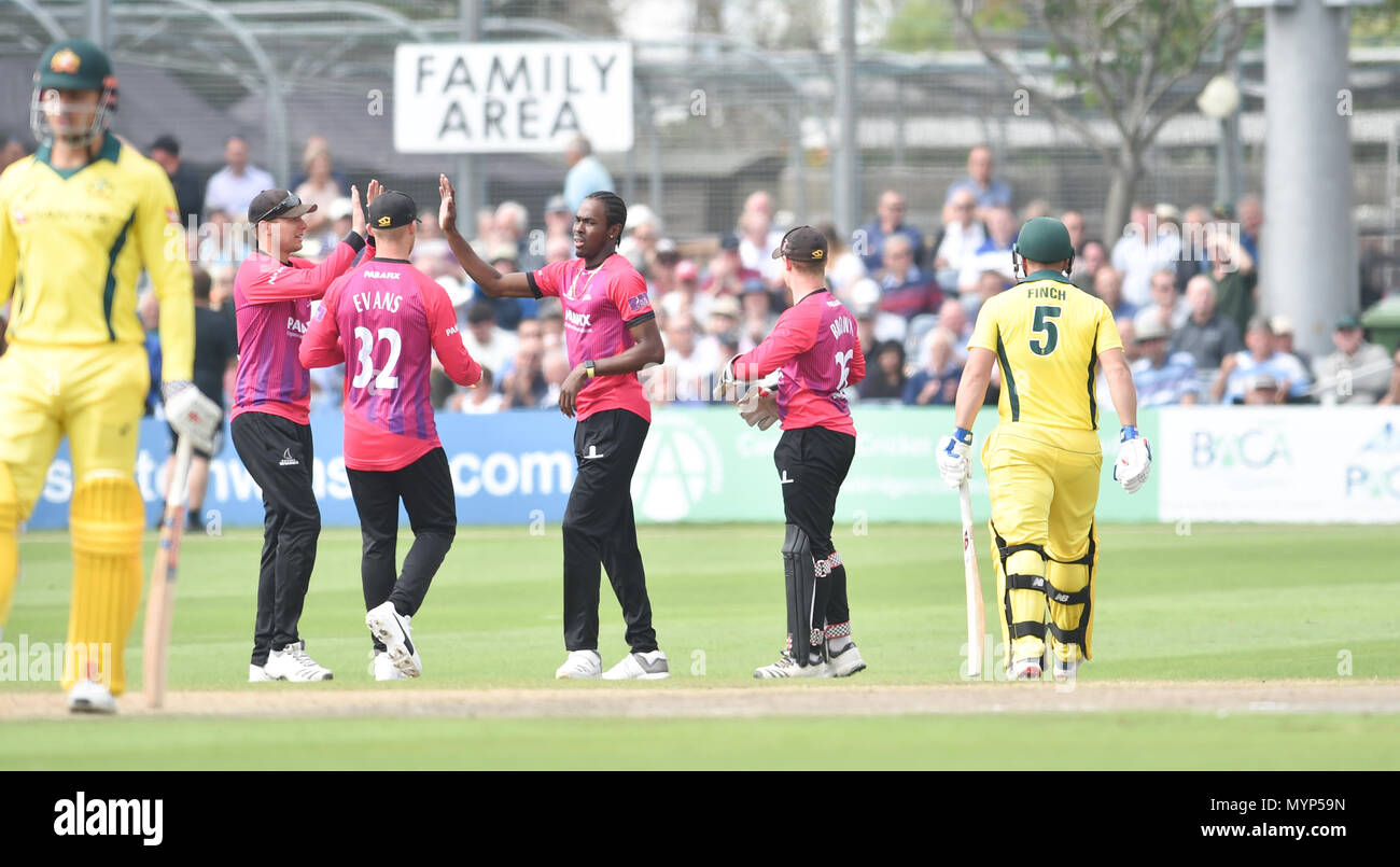 Sussex bowler Jofra Archer (centre) celebrates after getting the wicket of Australias Aaron Finch  during the 50 over cricket tour match between Sussex and Australia at The 1st Central County Ground in Hove. 07 June 2018 Stock Photo