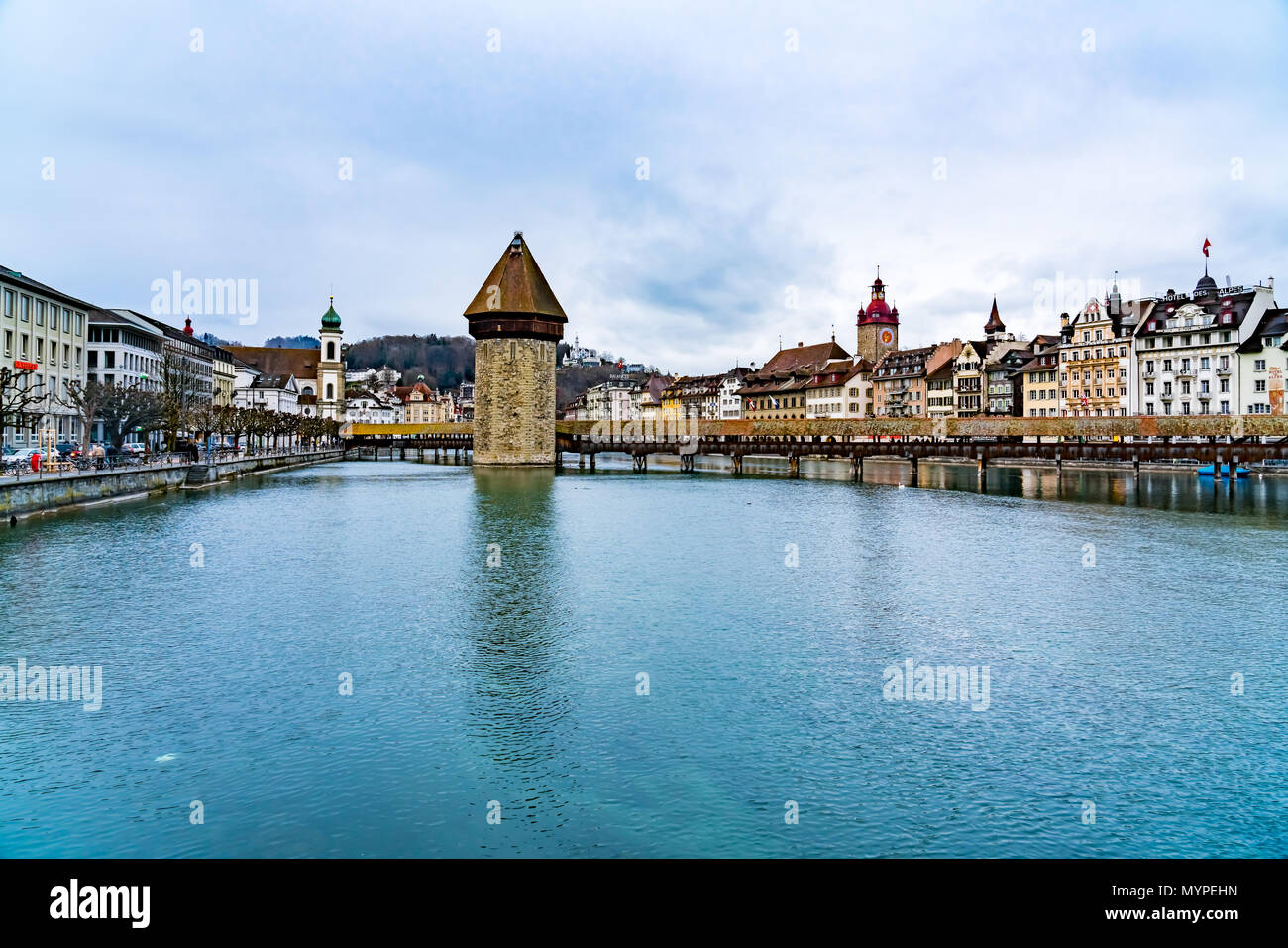 LUCERNE, SWITZERLAND - MARCH 30, 2018 : View of the european building of the historic old city of Lucerne with the Wooden Chapel Bridge and the lake L Stock Photo
