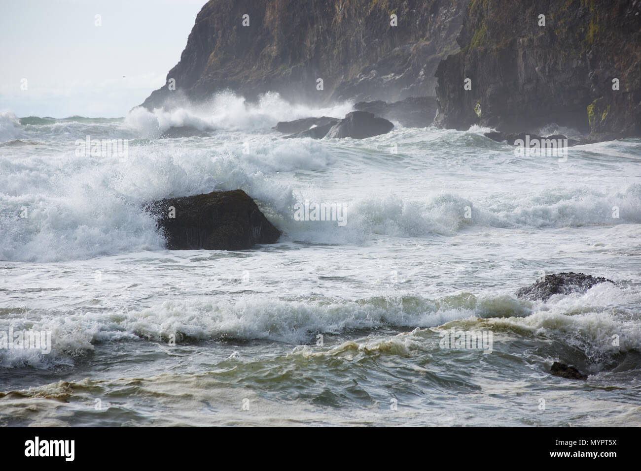 Waves overwhelm a rock off Cape Meares, Tillamook County, Oregon. Stock Photo