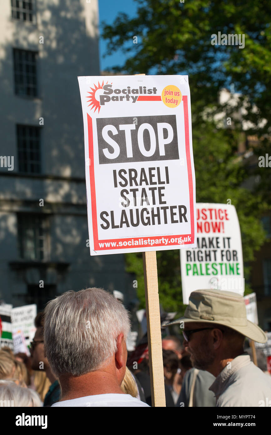 Protesters with placards at the Gaza: Stop The Massacre rally in Whitehall, London, in protest of Palestinian civilians killed by Israeli military. Stock Photo