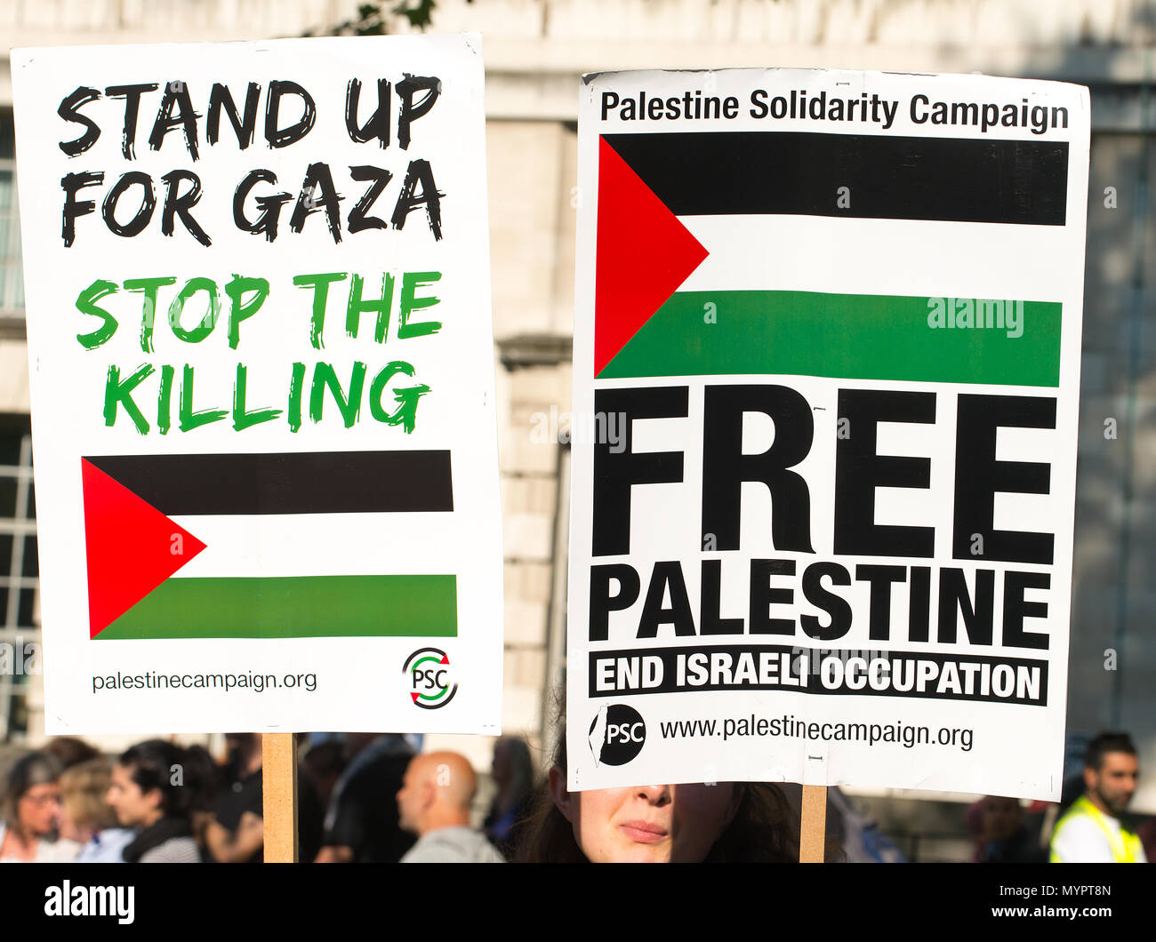 Protesters with placards at the Gaza: Stop The Massacre rally in Whitehall, London, in protest of Palestinian civilians killed by Israeli military. Stock Photo