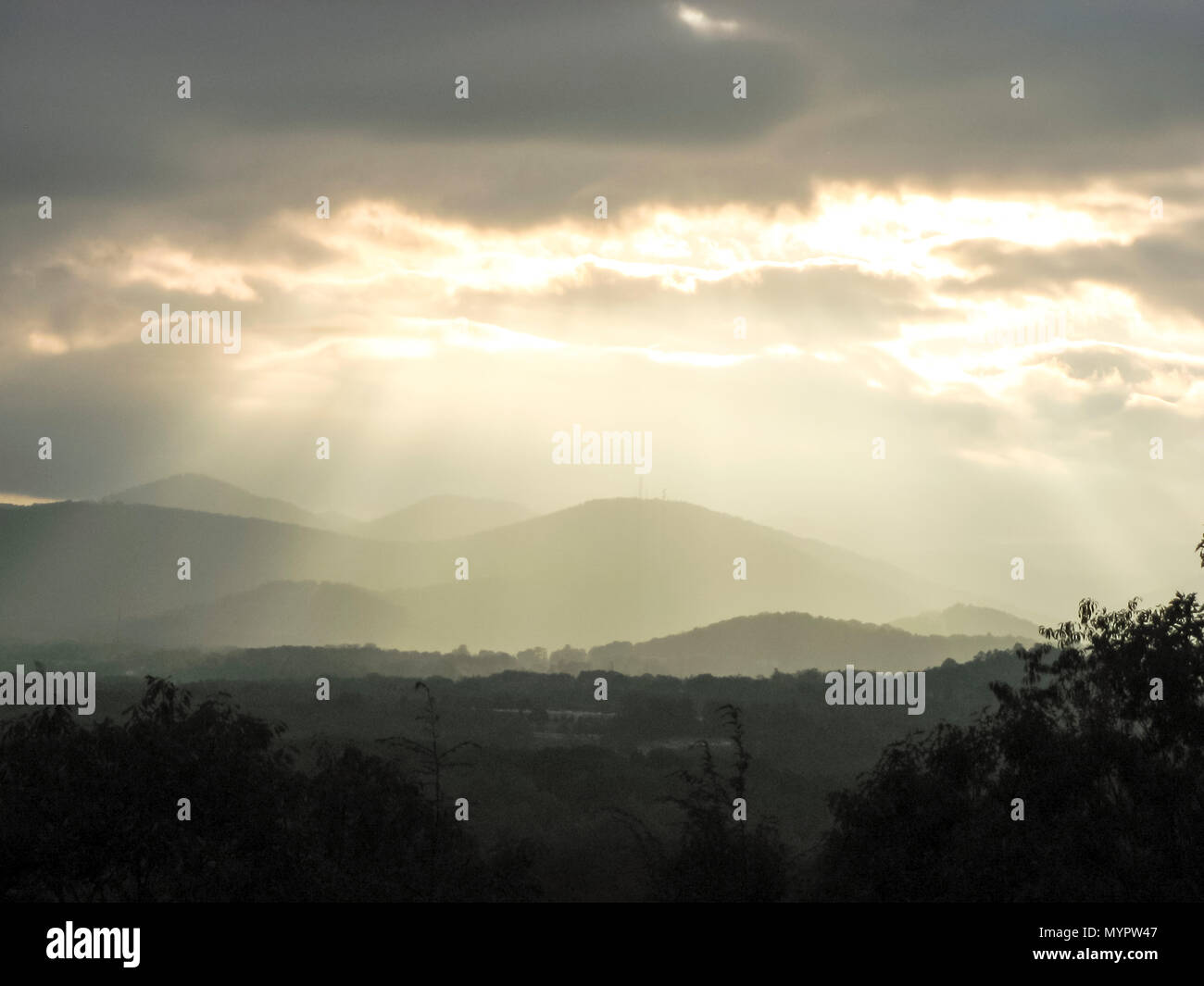 rays shine from clouds after storm over the Blue Ridge Mountains  Asheville, North Carolina. Stock Photo