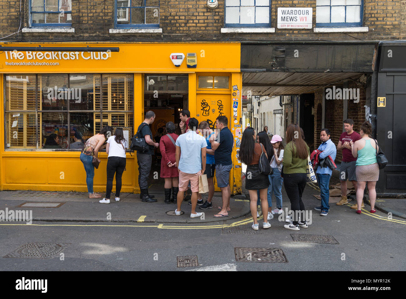 People queuing for entry to the Breakfast Club restaurant, Soho, London, England, UK Stock Photo