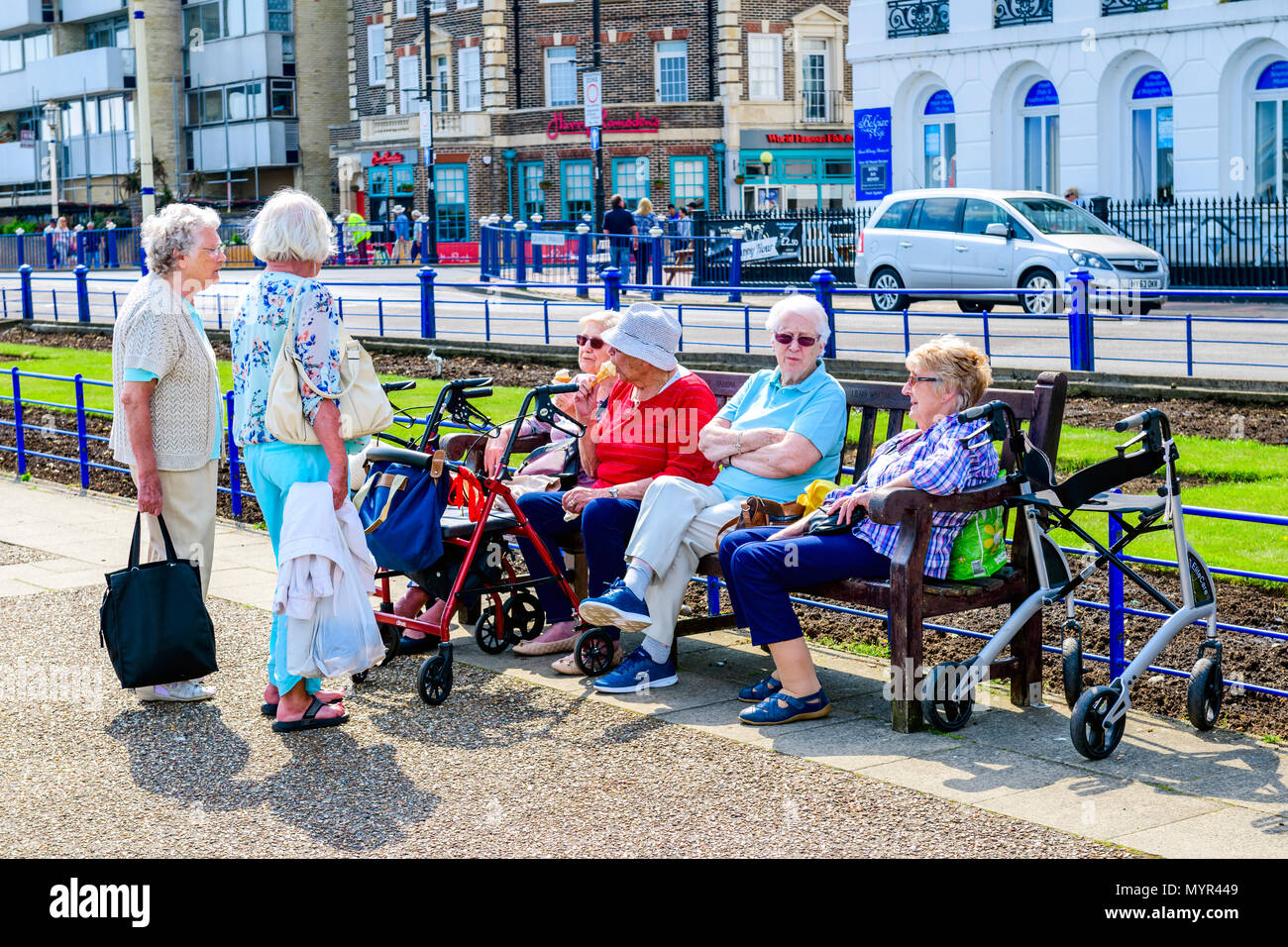 Group of senior ladies gathering for a chat. Eastbourne promenade, Stock Photo