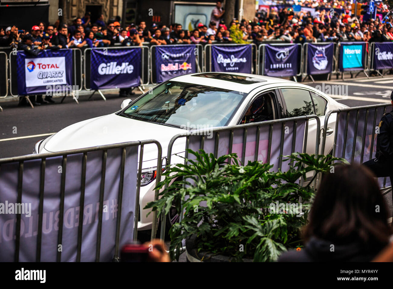 Mexico City, Mexico - June 27, 2015: Carlos Sainz driving a White Infinity Q50, at the Infiniti Red Bull Racing F1 Showrun. Stock Photo