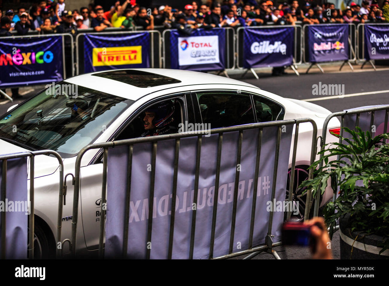 Mexico City, Mexico - June 27, 2015: Carlos Sainz driving a White Infinity Q50, at the Infiniti Red Bull Racing F1 Showrun. Stock Photo