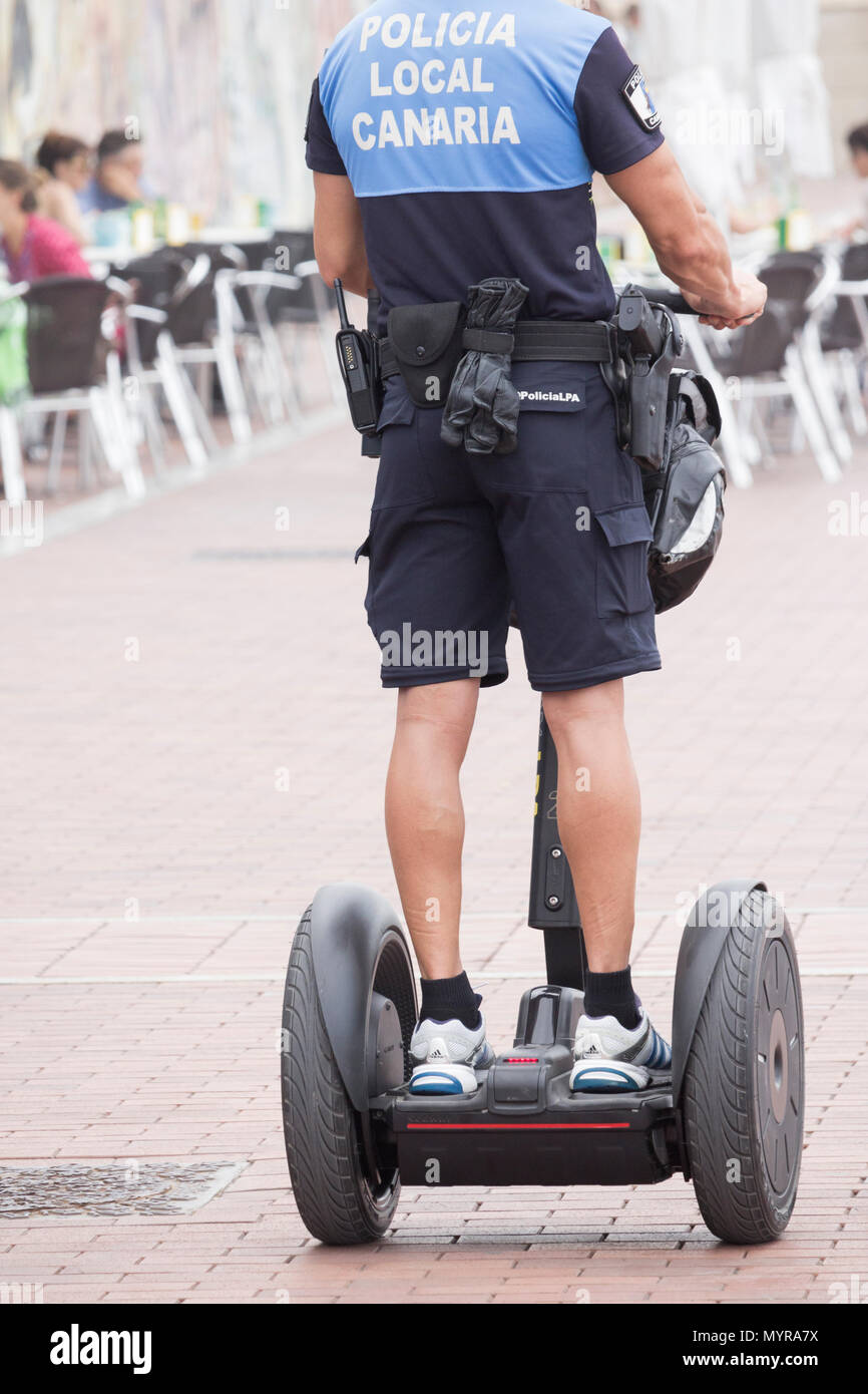 Spanish police/policeman patrolling city beach promenade on Segway in Las Palmas, Gran Canaria, Canary Islands, Spain Stock Photo