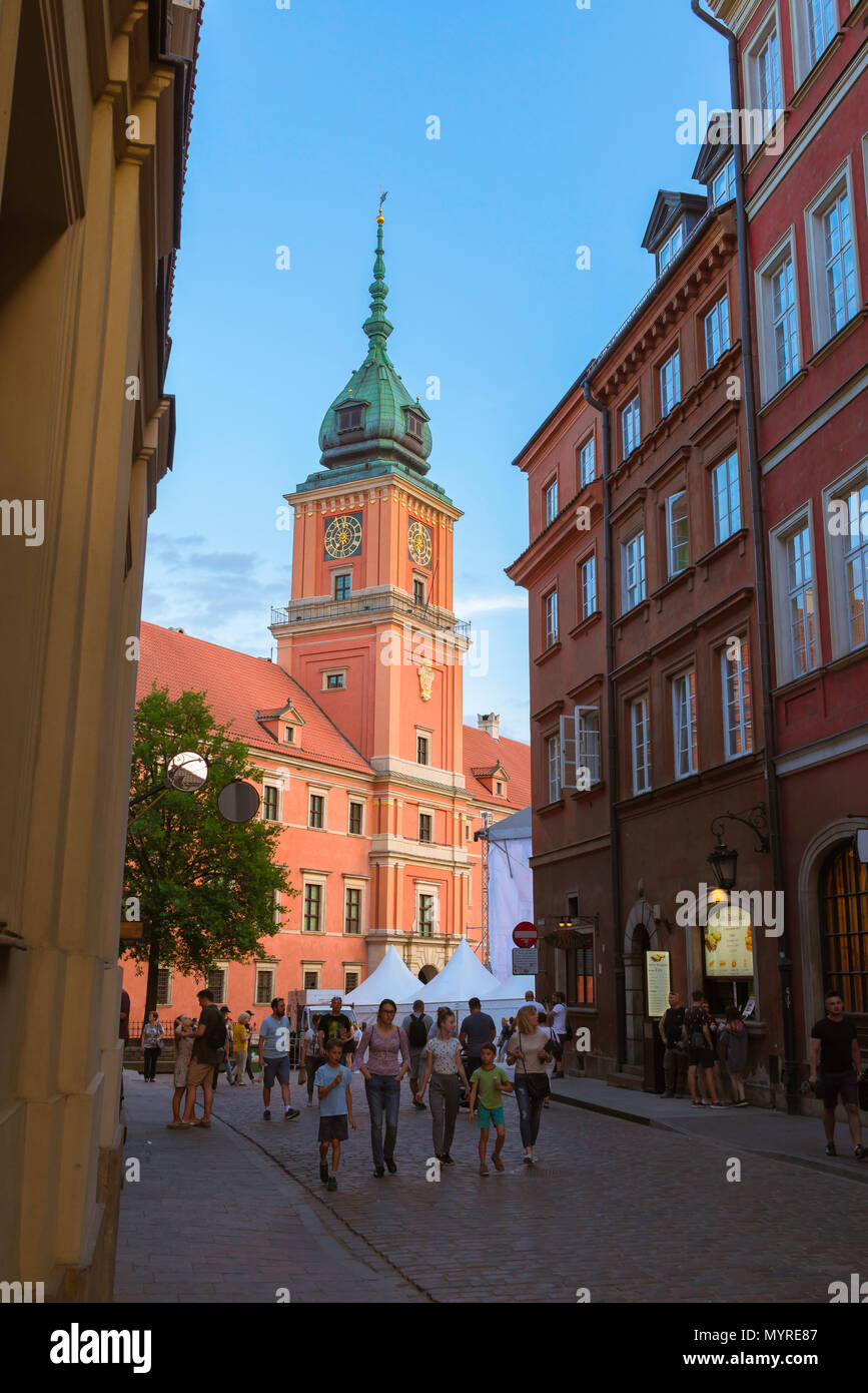 Old Town Warsaw, view at dusk of people walking in the Old Town quarter with the Royal Castle in the background, Warsaw, Poland. Stock Photo