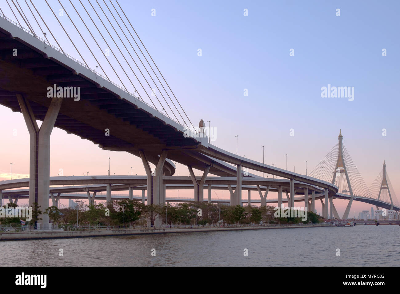 View of elevated expressway cross the river at twilight. Stock Photo
