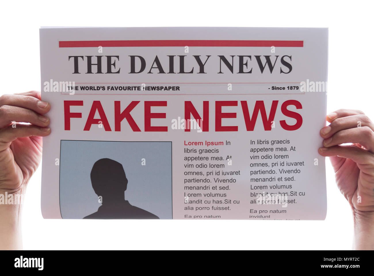 Woman holding up a newspaper with the headline fake news Stock Photo