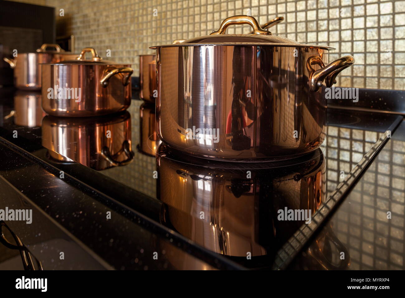 Copper cookware on the stove Stock Photo Alamy
