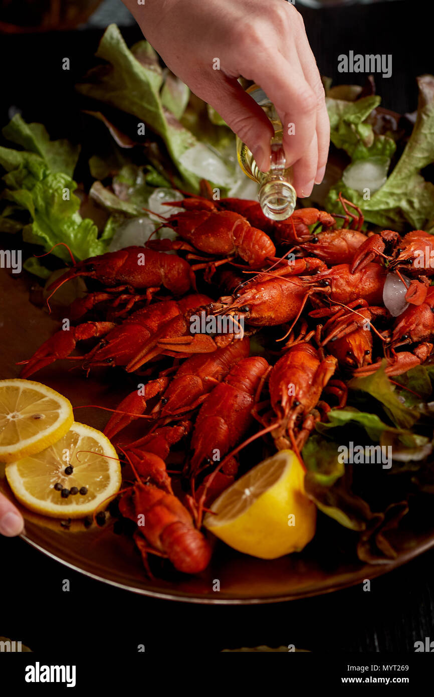 A lobster on a big Golden platter. Scatter the lemon and the Bay leaf