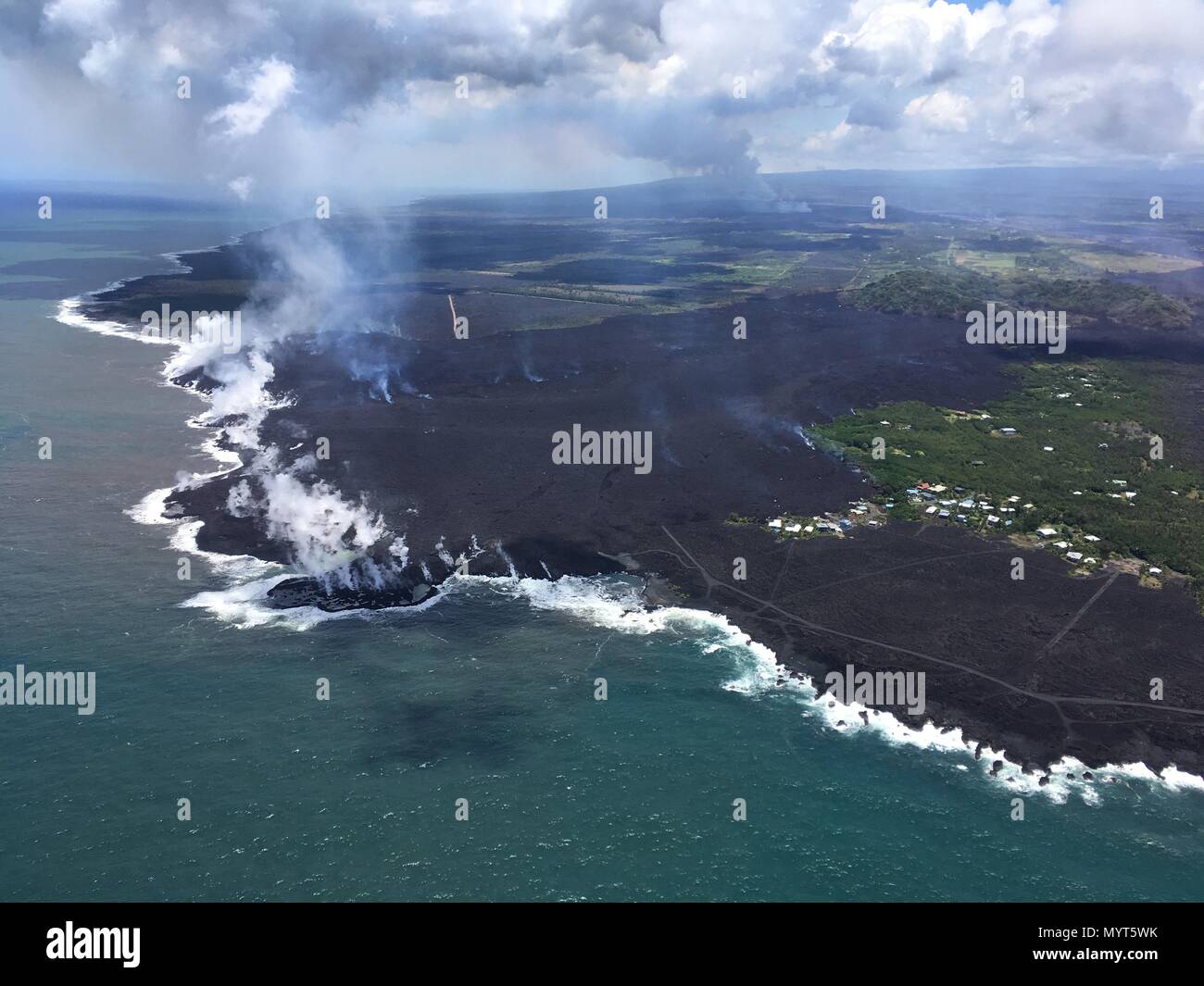 Hawaii, USA. 6th June, 2018. Lava flows into Kapoho Bay destroying forest and homes in the Vacationland area caused by the eruption of the Kilauea volcano June 6, 2018 in Hawaii. The recent eruption continues destroying homes, forcing evacuations and spewing lava and poison gas on the Big Island of Hawaii. Credit: Planetpix/Alamy Live News Stock Photo