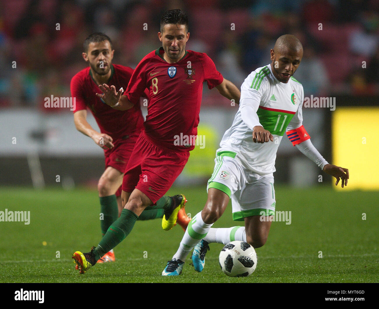 Lisbon, Portugal. 7th June, 2018. Joao Moutinho (C) of Portugal vies with Yacine Brahimi (R) of Algeria during the international friendly soccer match between Portugal and Algeria at Luz Stadium in Lisbon, Portugal, on June 7, 2018. Portugal won 3-0. Credit: Zhang Liyun/Xinhua/Alamy Live News Stock Photo