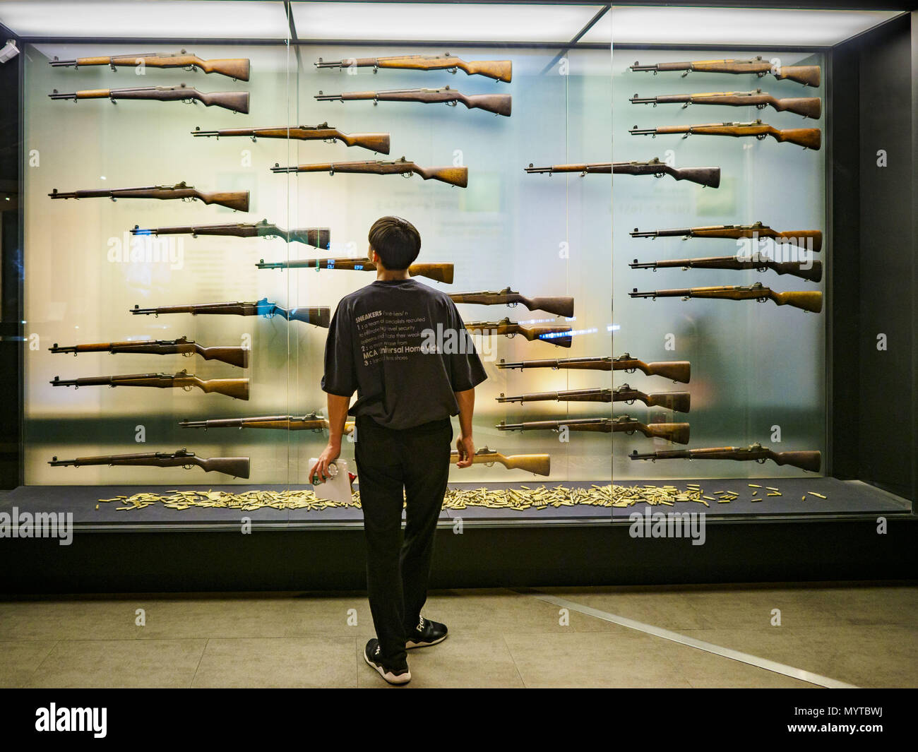 June 8, 2018 - Seoul, Gyeonggi, South Korea - A teenager looks at a display of M1 Garand rifles at the War Memorial of Korea in Seoul, South Korea. The M1 was carried by US soldiers in the Korean War and was the South Korean service rifle for many years. With the near constant threat of invasion from North Korea, many South Koreans take great pride in the ability of their armed forces. Some observers believe there is a possibility that a peace agreement between South and North Korea could be signed following the Trump/Kim summit in Singapore. The War Memorial and museum opened in 1994 on the f Stock Photo