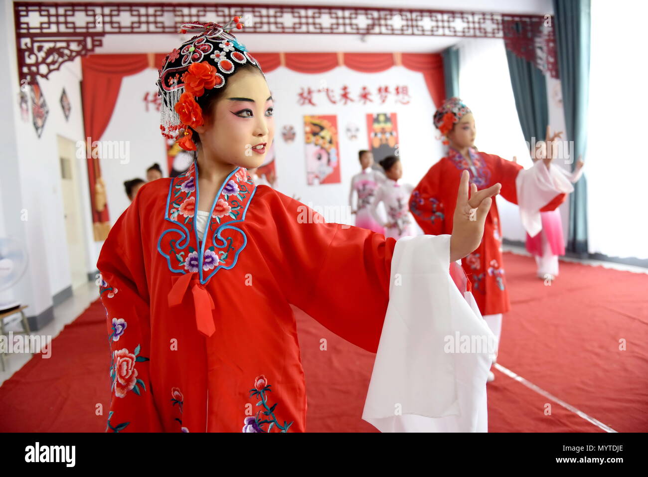 Neiqiu, China's Hebei Province. 8th June, 2018. Students practice basic performing actions of Chinese drama at a primary school in Neiqiu County, north China's Hebei Province, June 8, 2018. The school introduced Chinese drama to student class to make it a way of inheriting traditional Chinese culture. Credit: Zhu Xudong/Xinhua/Alamy Live News Stock Photo
