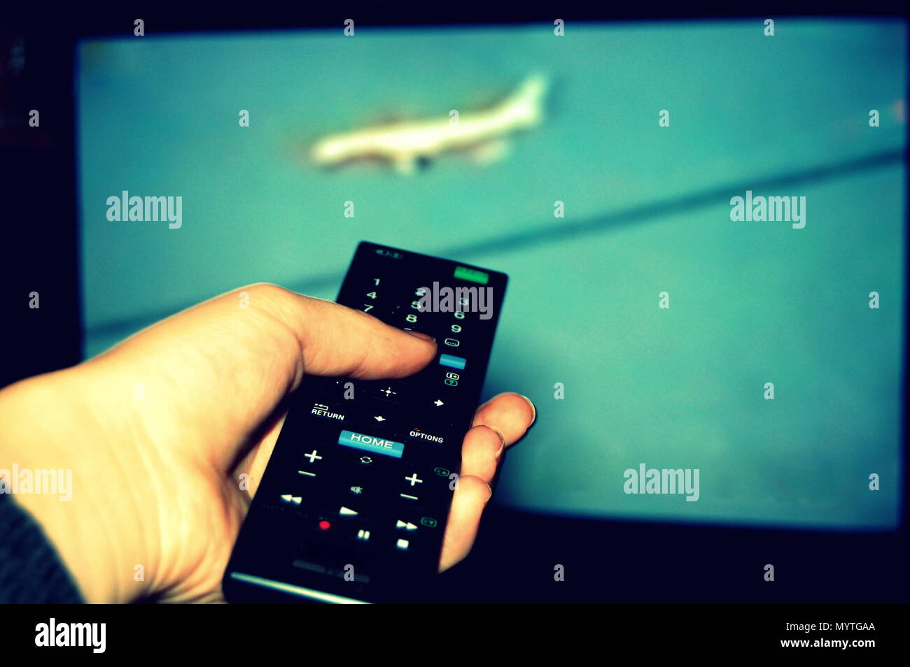 watching television, zapping with the remote control Stock Photo - Alamy