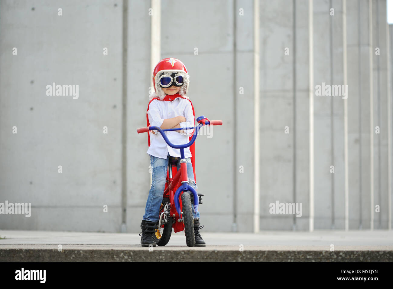 A funny, little superhero. Concept boy imagination. Happy childchood. Stock Photo